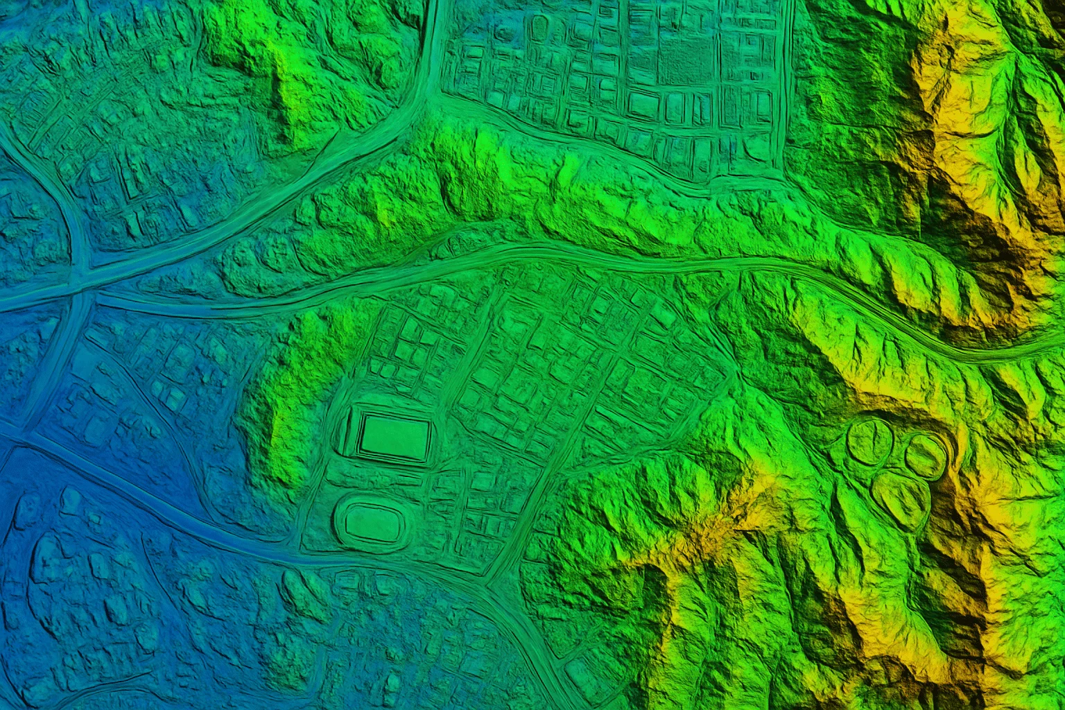 Color-coded topographic map from an aerial survey showing elevation variations in green, yellow, and blue for urban and terrain analysis.